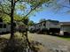 RV sitting on a gravel lot with some shade from the surrounding trees at 103 Hidaway Trl # 99A, Mount Gilead, NC 27306