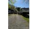 RV sitting on a lot with gravel parking and a small storage shed behind at 103 Hidaway Trl # 99A, Mount Gilead, NC 27306