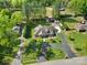 An aerial view showing the house on a large lot with a long driveway and multiple sheds at 10416 Glenmac Rd, Charlotte, NC 28215