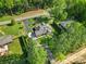 The house sits on a lot near woods and other houses, a long driveway leading up to it at 10416 Glenmac Rd, Charlotte, NC 28215