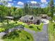 Aerial view of a home with long driveway, manicured lawn and separate garage at 10416 Glenmac Rd, Charlotte, NC 28215
