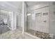 Elegant bathroom with a glass-enclosed shower and pebble flooring, adding a touch of luxury at 10416 Glenmac Rd, Charlotte, NC 28215