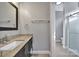 Contemporary bathroom featuring a stylish vanity, a modern mirror, and a glass-enclosed shower at 10416 Glenmac Rd, Charlotte, NC 28215