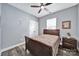 Comfortable bedroom with neutral paint, hardwood floors and a ceiling fan, creating a cozy and inviting atmosphere at 10416 Glenmac Rd, Charlotte, NC 28215