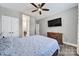 Bright bedroom with a ceiling fan, TV, and a closet, creating a comfortable and functional space at 10416 Glenmac Rd, Charlotte, NC 28215