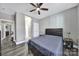 Inviting bedroom with a comfortable bed, a ceiling fan, and ample natural light, creating a relaxing atmosphere at 10416 Glenmac Rd, Charlotte, NC 28215
