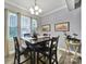 Cozy dining room with a modern chandelier and a dark wood table set, perfect for Gathering meals at 10416 Glenmac Rd, Charlotte, NC 28215