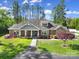 Beautiful single-story home with manicured lawn, brick and stone accents, and a welcoming front porch at 10416 Glenmac Rd, Charlotte, NC 28215