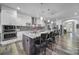 Modern kitchen with a large island, pendant lighting, stainless steel appliances, and white cabinetry at 10416 Glenmac Rd, Charlotte, NC 28215