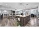 Open kitchen with a large island, seamlessly connecting to the living room and dining area at 10416 Glenmac Rd, Charlotte, NC 28215