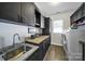 Functional laundry room with ample counter space, dark cabinetry, and modern appliances for efficient chores at 10416 Glenmac Rd, Charlotte, NC 28215