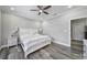 Spacious main bedroom with hardwood floors and a decorative ceiling fan, offering comfort and style at 10416 Glenmac Rd, Charlotte, NC 28215