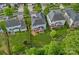 Aerial view of the property with a fenced backyard, mature trees, and a charming screened-in porch at 10423 Drake Hill Dr, Huntersville, NC 28078