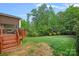 Backyard with a deck, green grass and mature trees at 10423 Drake Hill Dr, Huntersville, NC 28078