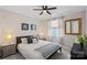 Comfortable bedroom features a large window, ceiling fan, and neutral decor at 10423 Drake Hill Dr, Huntersville, NC 28078