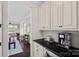 Convenient butler's pantry with granite countertop and white cabinets, providing extra storage near the kitchen at 10423 Drake Hill Dr, Huntersville, NC 28078
