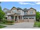 Inviting two-story home with a covered front porch and two-car garage, perfect for a growing Gathering at 10423 Drake Hill Dr, Huntersville, NC 28078