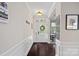 Welcoming foyer with hardwood floors, white wainscoting, and ample natural light, creating a warm entry at 10423 Drake Hill Dr, Huntersville, NC 28078