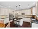 Well-lit kitchen featuring white cabinetry, dark countertops, stainless steel appliances, and an island with bar seating at 10423 Drake Hill Dr, Huntersville, NC 28078