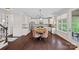 Spacious kitchen with island and dining area featuring wooden floors and white cabinets, creating a warm atmosphere at 10423 Drake Hill Dr, Huntersville, NC 28078