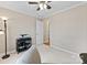 Neutral bedroom featuring a ceiling fan, doorway, and furniture, offering a calming atmosphere at 109 Wren Ln, Mooresville, NC 28117