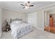 Carpeted bedroom with a double door closet, a ceiling fan and a side table with a lamp at 109 Wren Ln, Mooresville, NC 28117