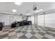 Spacious garage with tiled floor, features a black sports car and overhead lighting, providing ample parking at 109 Wren Ln, Mooresville, NC 28117