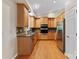 Well-lit kitchen features stainless steel appliances, granite countertops, and wood cabinets with ample storage space at 109 Wren Ln, Mooresville, NC 28117
