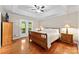 Spacious main bedroom features tray ceiling, wood flooring, and access to the outdoor balcony at 109 Wren Ln, Mooresville, NC 28117