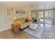 Cozy sunroom with wood-look tile flooring, comfortable seating, and plenty of natural light at 109 Wren Ln, Mooresville, NC 28117