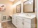 Bright bathroom featuring double sinks with white cabinets and countertops, and a large mirror at 1308 Twin Oaks Dr, Chester, SC 29706