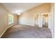 Carpeted bedroom with large window offering natural light, neutral paint and simple chandelier at 1308 Twin Oaks Dr, Chester, SC 29706