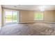 Bright carpeted bedroom featuring a sliding glass door leading to a deck and natural light at 1308 Twin Oaks Dr, Chester, SC 29706