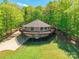 Unique round house exterior boasts a surrounding deck, lush greenery, and ample parking space at 1308 Twin Oaks Dr, Chester, SC 29706