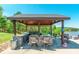 Gazebo overlooking a lake with barstool seating around a stone countertop at 1308 Twin Oaks Dr, Chester, SC 29706