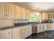 Bright kitchen with light wood cabinets, granite countertops, stainless steel appliances and hardwood floors at 1308 Twin Oaks Dr, Chester, SC 29706
