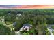 Aerial view of a luxury home surrounded by mature trees and lush landscaping at 133 Crooked Branch Way, Troutman, NC 28166