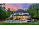 Stunning backyard oasis with a sparkling pool, manicured landscaping, and inviting outdoor living space with fence and string lights at 133 Crooked Branch Way, Troutman, NC 28166