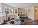 Home gym with various weights, exercise bench, floor mats and motivational signage on the walls at 133 Crooked Branch Way, Troutman, NC 28166