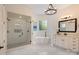 Bright bathroom featuring a glass shower, soaking tub, and double sink vanity at 133 Crooked Branch Way, Troutman, NC 28166