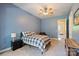 Comfortable bedroom featuring a ceiling fan, soft carpet, and a charming plaid bedspread at 133 Crooked Branch Way, Troutman, NC 28166