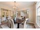 Elegant dining room with a stylish chandelier, large table, and seamless flow to other living spaces at 133 Crooked Branch Way, Troutman, NC 28166