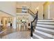 Grand foyer showcasing a curved staircase, hardwood floors, and an open floor plan with bright natural light at 133 Crooked Branch Way, Troutman, NC 28166