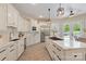 Bright kitchen featuring custom cabinets, an island with seating, and modern stainless steel appliances at 133 Crooked Branch Way, Troutman, NC 28166