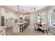 Gourmet kitchen features an island with stools, and stainless steel appliances; a lovely breakfast nook is also visible at 133 Crooked Branch Way, Troutman, NC 28166