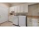 Laundry room with sink, washer, dryer, and abundant cabinet space at 133 Crooked Branch Way, Troutman, NC 28166