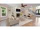 Bright and inviting living room featuring a fireplace, built-in shelving, and hardwood floors at 133 Crooked Branch Way, Troutman, NC 28166
