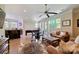 Open living room featuring a sofa, wood floors, and wet bar in background at 133 Crooked Branch Way, Troutman, NC 28166