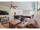 Open living room with sofa, wood floors, TV, and open wet bar in background at 133 Crooked Branch Way, Troutman, NC 28166