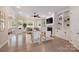 Spacious living room features a fireplace, built-in bookshelves, large windows, and hardwood floors at 133 Crooked Branch Way, Troutman, NC 28166